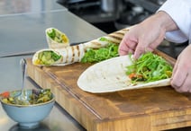 A wrap being freshly prepared by one of our chefs