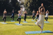 Group of people enjoying a guided meditation in the sun