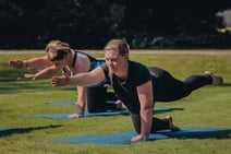 Group of people enjoying a guided yoga session in the sun