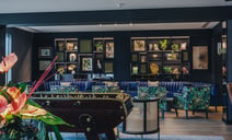 The Live Lounge showcases blue decor and furniture, creating a vibrant lounge space with table football at the Runnymede on Thames.