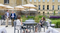 Guests gathering on the outdoor terrace with drinks to celebrate