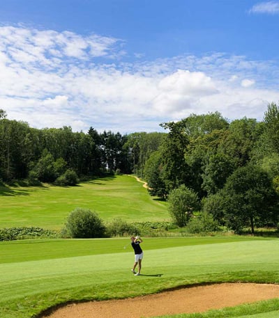 Man playing golf on a sunny day