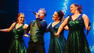 Singers on stage performing a festive show