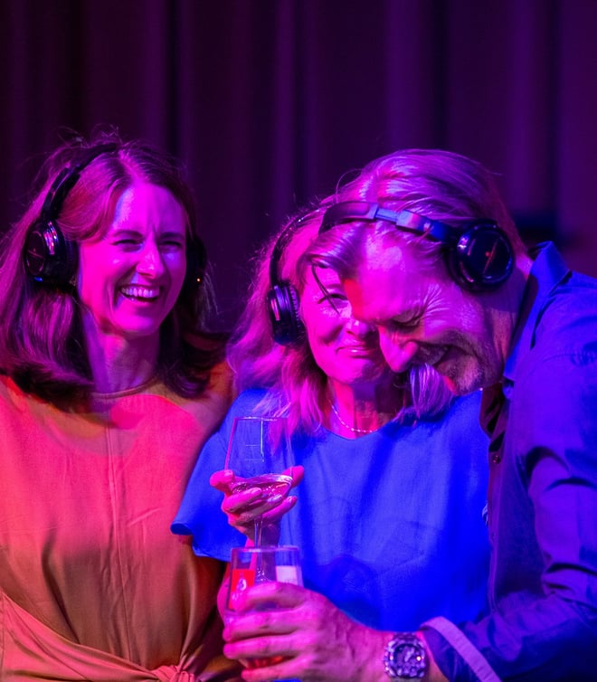 Guests laughing together as they experience a silent disco