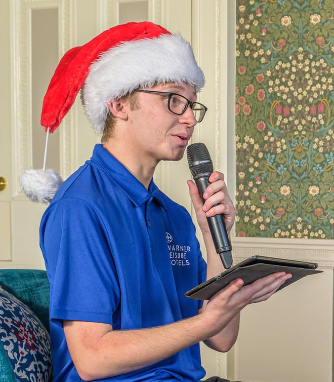 A Warner Hotels team member leading the Christmas Quiz