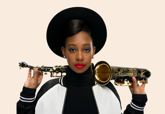 YolanDa Brown with a saxophone on her shoulders