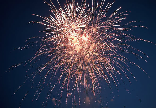 Golden fireworks against a dark blue sky