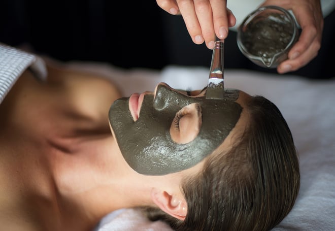 A person's face is coated in a mask during a facial at the spa at Heythrop Park, a Warner Hotel