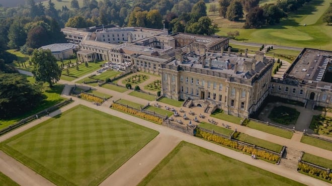 Stunning aerial shot of Heythrop Park Hotel, highlighting the mansion and its beautiful surrounding landscape.