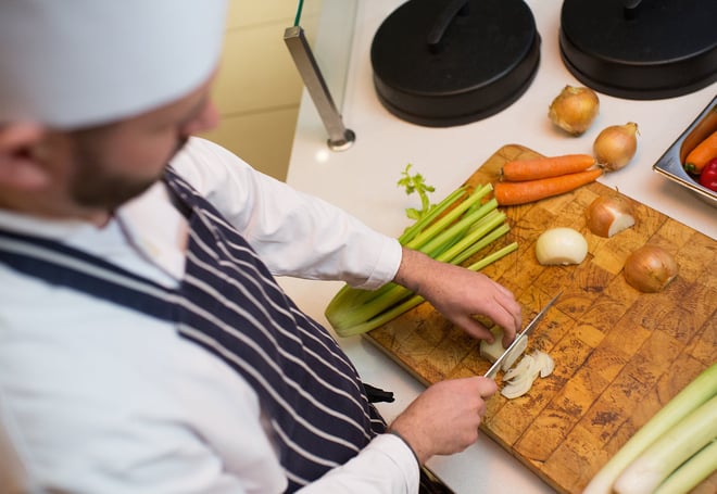 Birds eye view over a chef chopping onions