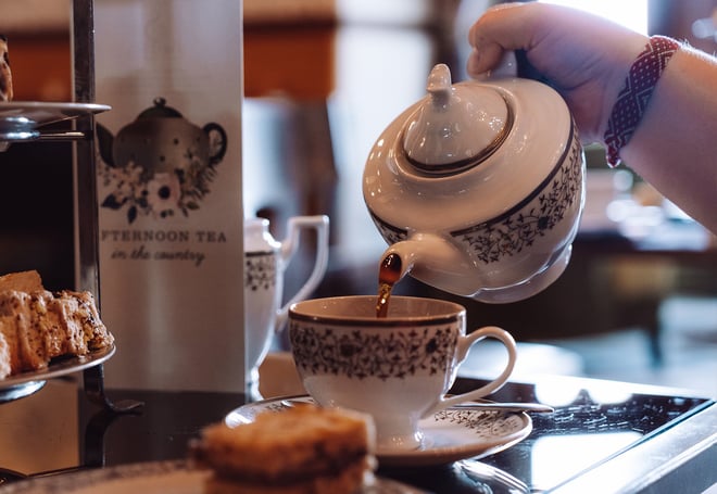 Close up of a guest pouring tea at afternoon tea