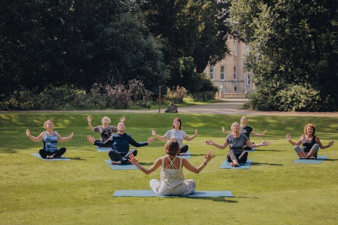 Group of people enjoying a guided meditation in the sun