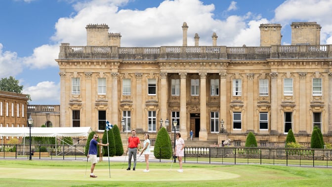 Golfers enjoying a game on the green at Heythrop Park.