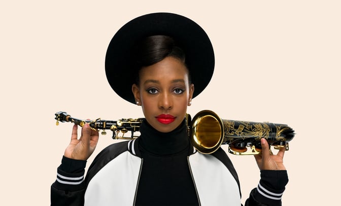 YolanDa Brown with a saxophone on her shoulders