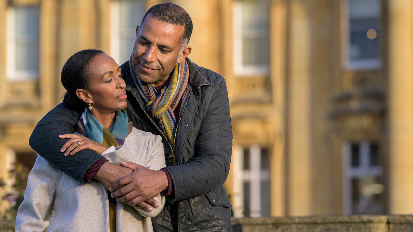 A couple embrace in front of Heythrop Park Hotel